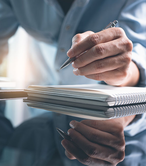 hand writing notes on a pad hand writing notes on a pad